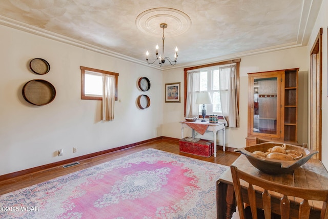 350 W Highland Ave, Ada, OH 45810 - home office with plenty of natural light, a chandelier, wood finished floors, and crown molding