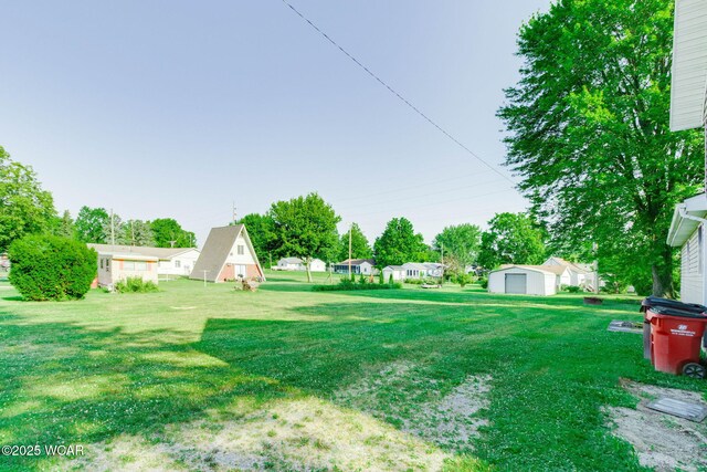 350 W Highland Ave, Ada, OH 45810 - view of green lawn with an outdoor structure and a garage