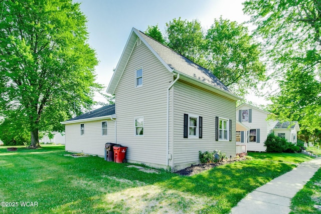 350 W Highland Ave, Ada, OH 45810 - view of property exterior with a yard