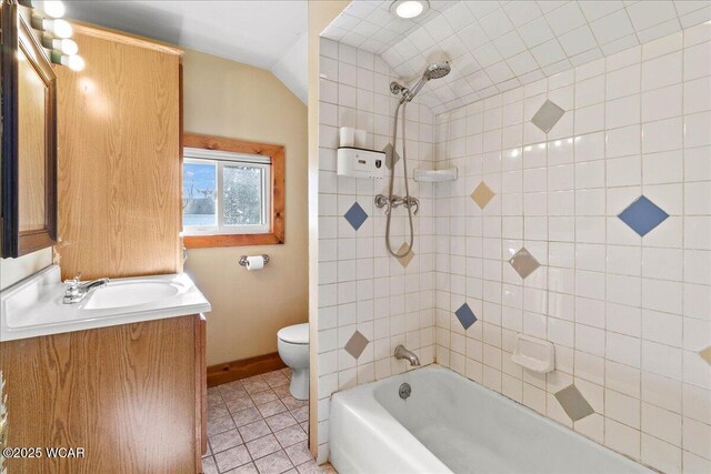 424 N Market St, Kenton, OH 43326 - bathroom featuring tile patterned floors, vaulted ceiling, toilet, vanity, and baseboards