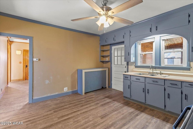 424 N Market St, Kenton, OH 43326 - kitchen featuring a ceiling fan, baseboards, a sink, and light wood-style floors