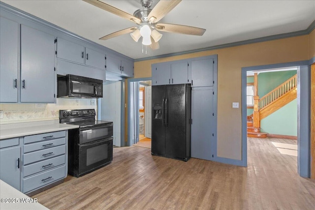 424 N Market St, Kenton, OH 43326 - kitchen featuring light wood-style floors, crown molding, ceiling fan, and black appliances
