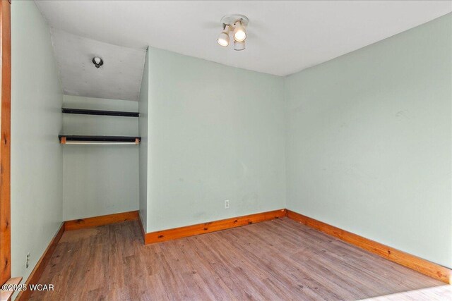 424 N Market St, Kenton, OH 43326 - unfurnished bedroom featuring wood finished floors, a closet, and baseboards