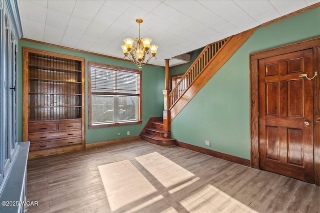 424 N Market St, Kenton, OH 43326 - interior space featuring stairs, wood finished floors, a chandelier, and ornamental molding