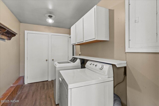 424 N Market St, Kenton, OH 43326 - clothes washing area featuring washing machine and dryer, electric panel, wood finished floors, and cabinet space