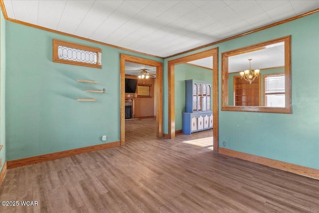 424 N Market St, Kenton, OH 43326 - empty room with a chandelier, wood finished floors, baseboards, and ornamental molding