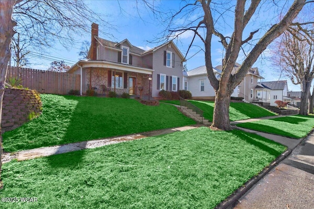 424 N Market St, Kenton, OH 43326 - traditional-style home with a porch, a chimney, a front lawn, and fence