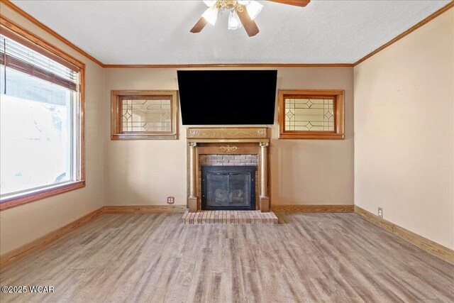 424 N Market St, Kenton, OH 43326 - unfurnished living room featuring plenty of natural light, a brick fireplace, ornamental molding, and wood finished floors