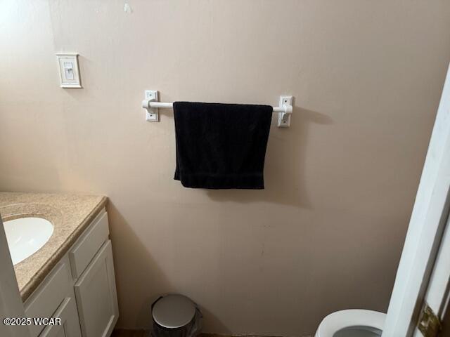 bathroom featuring toilet and vanity