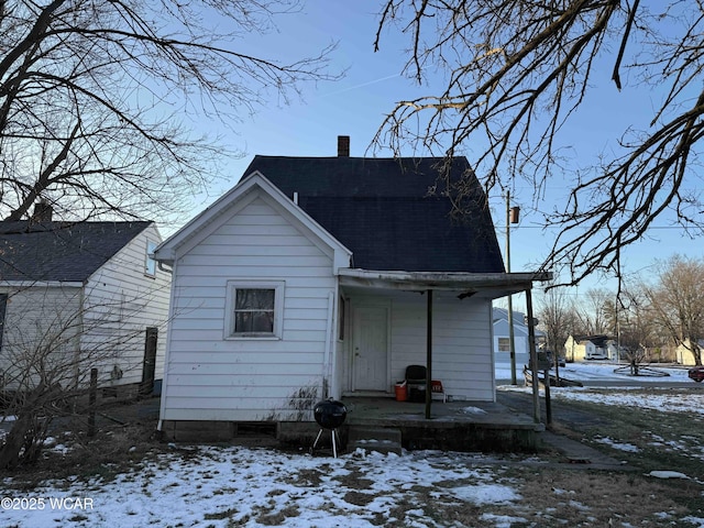 snow covered property featuring covered porch