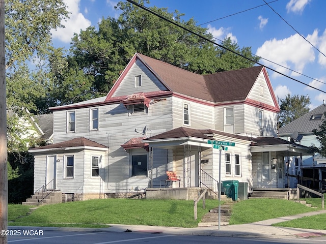 view of front facade with a porch and a front lawn