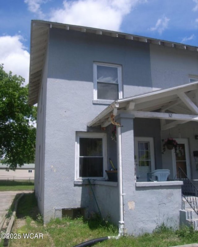 view of property exterior with a porch