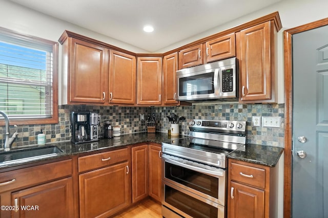 13286 Arrowhead Dr, Findlay, OH 45840 - kitchen with appliances with stainless steel finishes, backsplash, and brown cabinetry