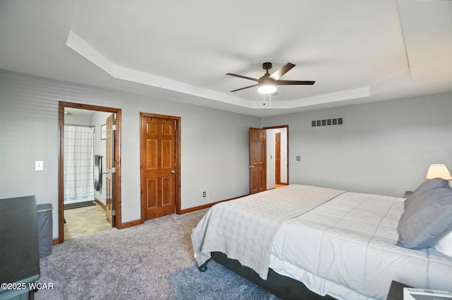 13286 Arrowhead Dr, Findlay, OH 45840 - carpeted bedroom featuring a tray ceiling, a ceiling fan, and ensuite bathroom