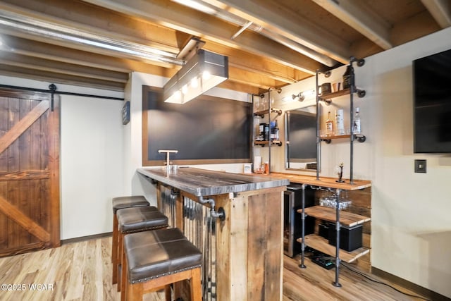 13286 Arrowhead Dr, Findlay, OH 45840 - indoor wet bar featuring light wood-style floors, a barn door, and beverage cooler