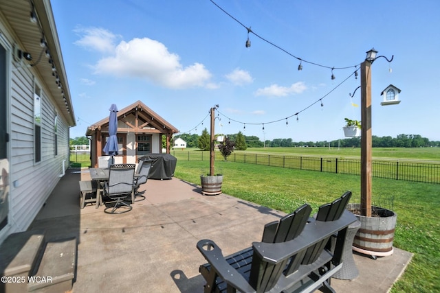 13286 Arrowhead Dr, Findlay, OH 45840 - fenced backyard featuring a patio area, outdoor dining area, a grill, and a rural view
