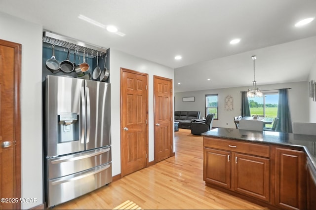 13286 Arrowhead Dr, Findlay, OH 45840 - kitchen featuring stainless steel fridge, light wood finished floors, brown cabinetry, recessed lighting, and hanging light fixtures