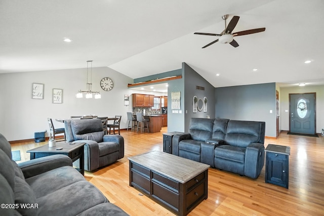 13286 Arrowhead Dr, Findlay, OH 45840 - living room featuring lofted ceiling, a ceiling fan, light wood-type flooring, recessed lighting, and a chandelier