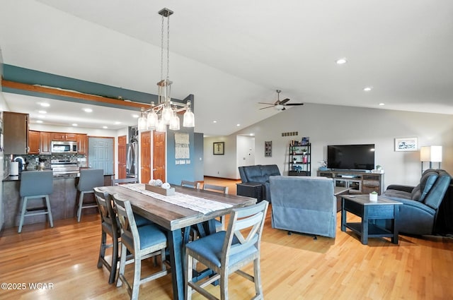 13286 Arrowhead Dr, Findlay, OH 45840 - dining area with light wood finished floors, a ceiling fan, lofted ceiling, and recessed lighting