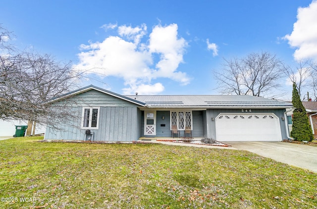 ranch-style house with an attached garage, a front lawn, metal roof, and concrete driveway