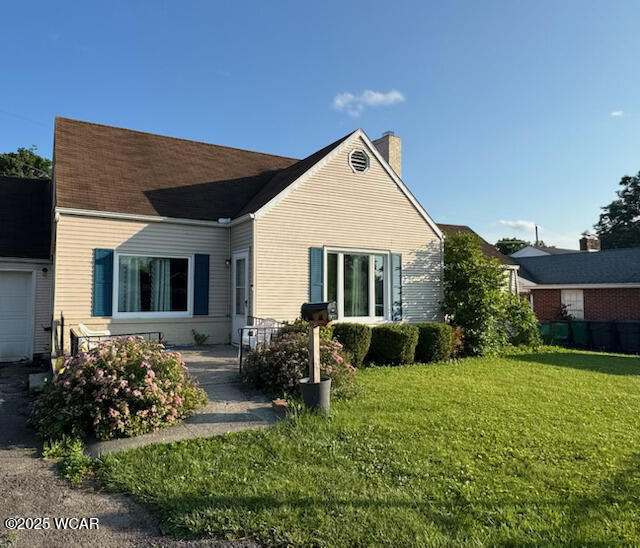 1919 Hillcrest Dr, Lima, OH 45805 - rear view of house with a chimney, a garage, and a yard
