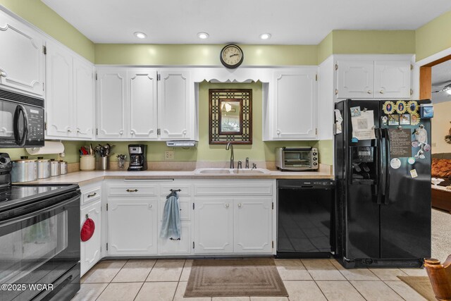 3540 Yoakam Rd, Lima, OH 45806 - kitchen featuring black appliances, a sink, light tile patterned flooring, light countertops, and white cabinetry