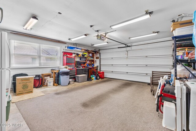 3540 Yoakam Rd, Lima, OH 45806 - garage featuring a garage door opener and freestanding refrigerator