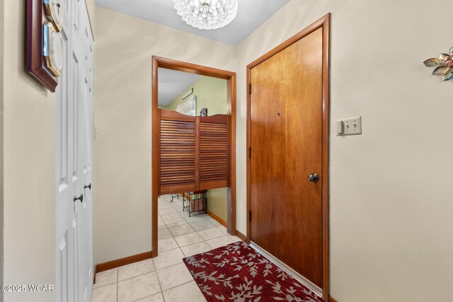 3540 Yoakam Rd, Lima, OH 45806 - corridor with a chandelier, baseboards, and light tile patterned flooring