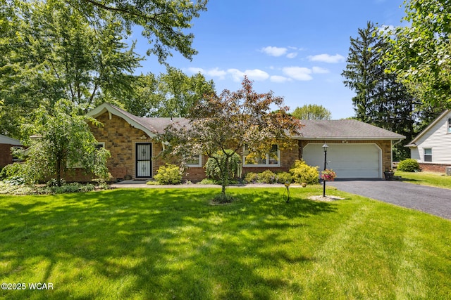3540 Yoakam Rd, Lima, OH 45806 - view of front of property featuring an attached garage, driveway, a front lawn, and stone siding