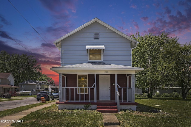 526 S Pine St, Lima, OH 45804 - view of front of home with a front yard, a porch, and roof with shingles