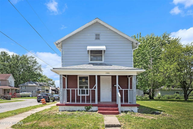 526 S Pine St, Lima, OH 45804 - view of front facade featuring a front yard, covered porch, and roof with shingles