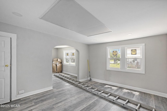 526 S Pine St, Lima, OH 45804 - spare room featuring baseboards, arched walkways, and wood finished floors