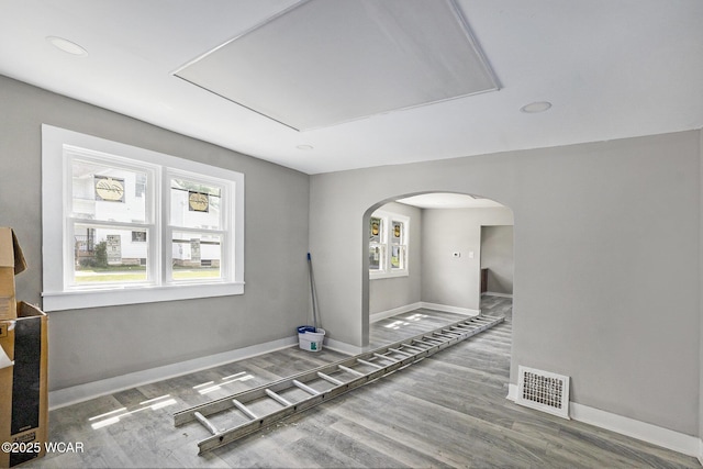 526 S Pine St, Lima, OH 45804 - spare room featuring arched walkways, baseboards, attic access, wood finished floors, and recessed lighting