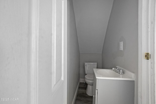 526 S Pine St, Lima, OH 45804 - half bath with toilet, vanity, lofted ceiling, wood finished floors, and baseboards