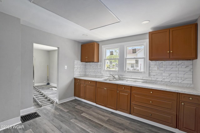 526 S Pine St, Lima, OH 45804 - kitchen with brown cabinetry, baseboards, dark wood-type flooring, and recessed lighting
