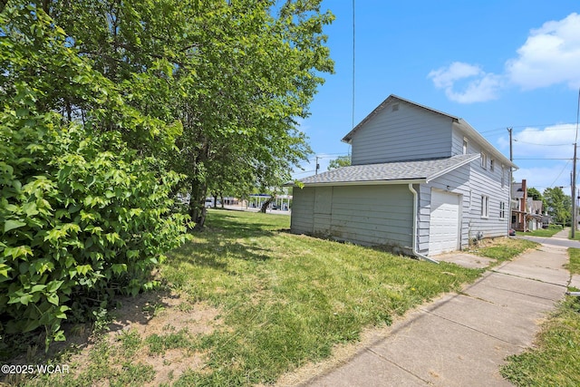 526 S Pine St, Lima, OH 45804 - view of home's exterior featuring a garage, a shingled roof, and a yard