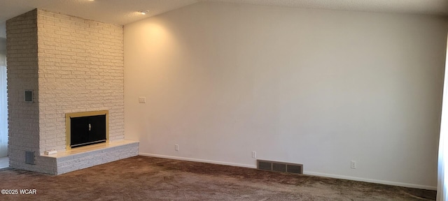 unfurnished living room with lofted ceiling, carpet flooring, a textured ceiling, and a fireplace