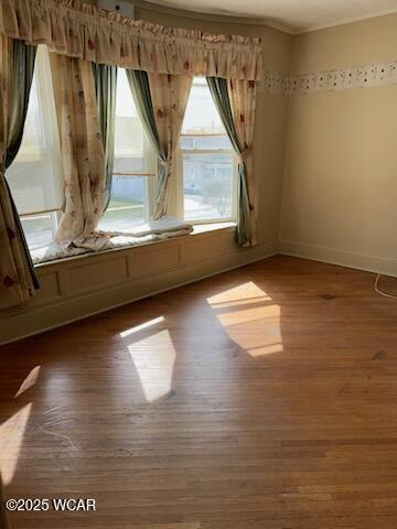 bedroom with hardwood / wood-style flooring and a wall unit AC