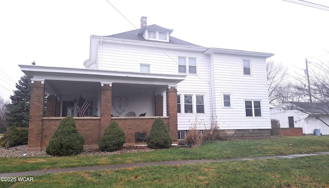 exterior space featuring covered porch and a front lawn