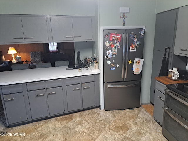 kitchen with appliances with stainless steel finishes and gray cabinetry