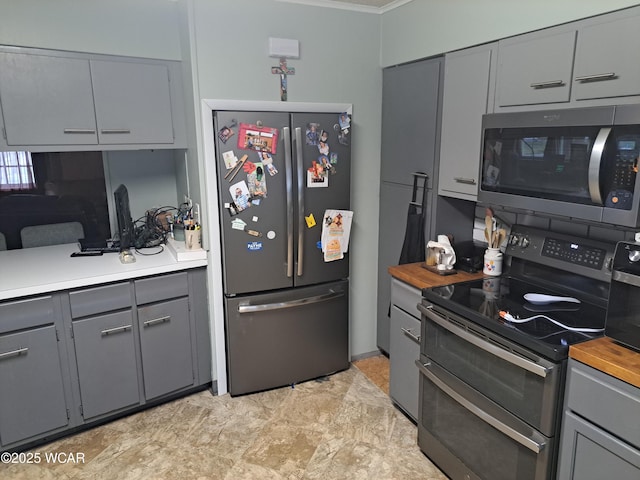 kitchen featuring stainless steel appliances and gray cabinetry