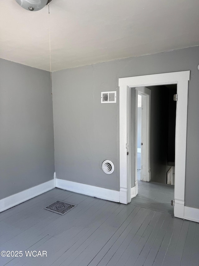 empty room with hardwood / wood-style flooring