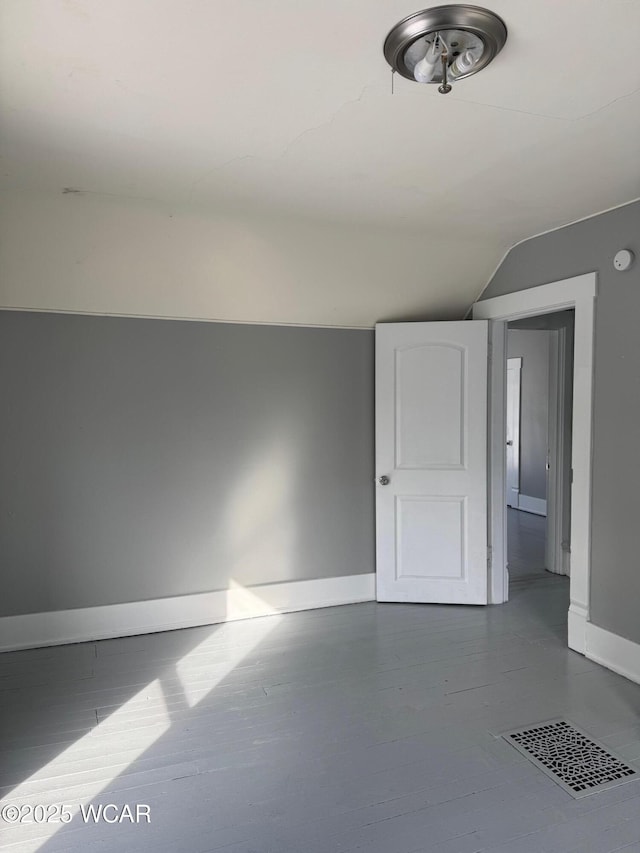 empty room with lofted ceiling