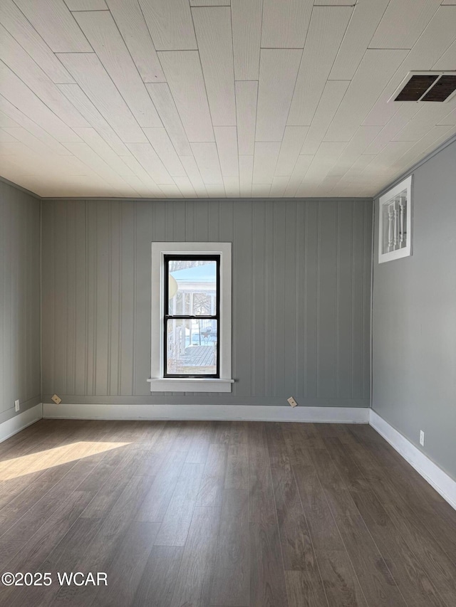 unfurnished room with dark wood-type flooring