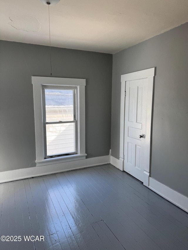 empty room with hardwood / wood-style flooring