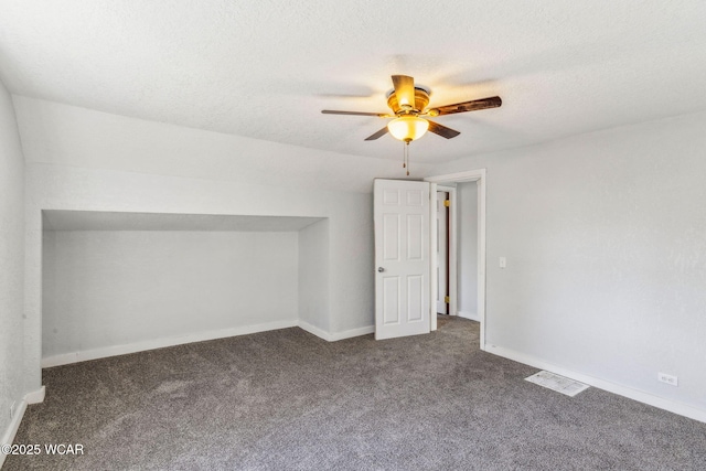 bonus room featuring visible vents, baseboards, carpet, vaulted ceiling, and a textured ceiling