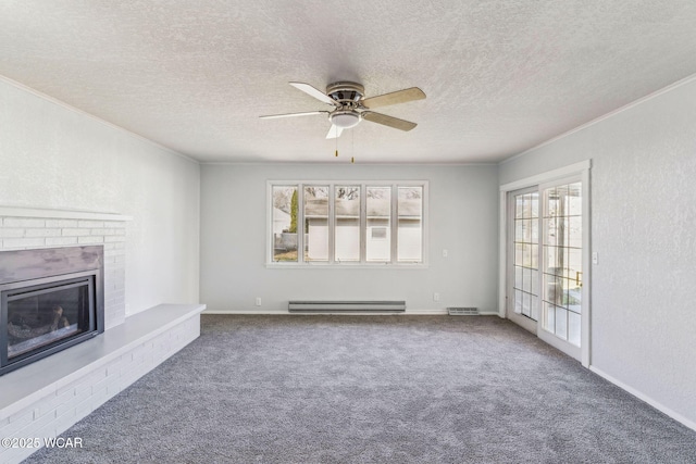 unfurnished living room featuring visible vents, carpet floors, ornamental molding, a fireplace, and a textured wall