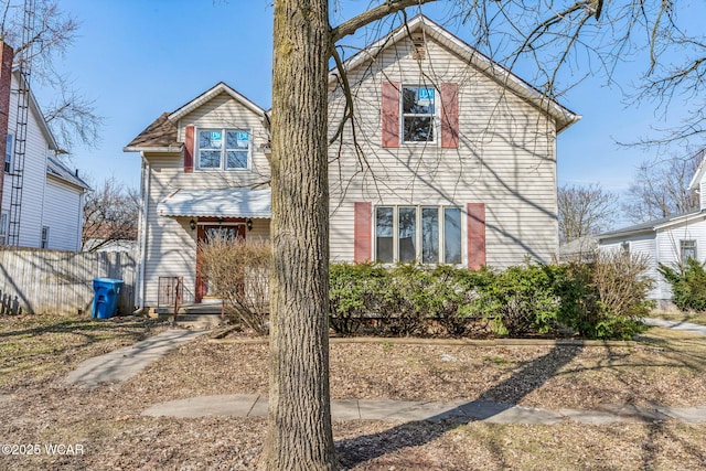 view of front of home featuring fence