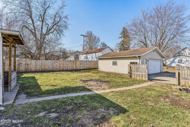 view of yard with an outbuilding, a garage, and fence