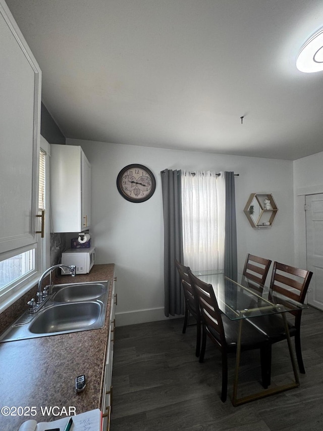 110 Heisel St, Kenton, OH 43326 - kitchen with dark wood finished floors, white cabinets, and dark countertops
